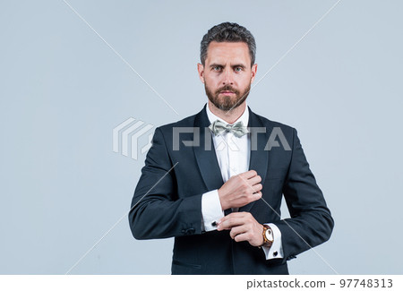 handsome man in tuxedo. confident businessman with bristle. male beauty and fashion. charismatic business man or manager. esthete wear bow tie. successful groomed mature aristocrat handsome man in tuxedo. confident businessman with bristle. male beauty and fashion. charismatic business man or manager. esthete wear bow tie. successful groomed mature aristocrat 97748313