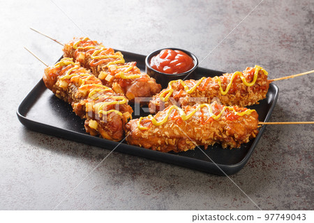 Korean style french fries corn dog Gamja hotdog closeup on the plate. Horizontal 97749043