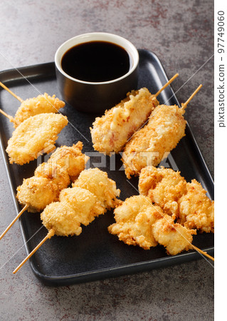Kushikatsu Japanese style deep-fried skewers closeup on the plate. Vertical 97749060