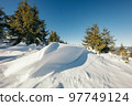A man flying through the air on a snow covered slope 97749124