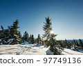 A man riding skis down a snow covered slope 97749136