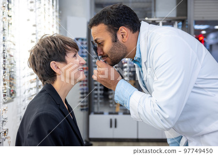 Mid aged woman having a visit to ophtolmalogical clinic 97749450