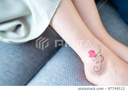 A woman with a tattoo on her ankle [parts cut] 97749512