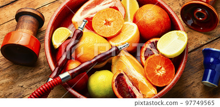 Smoking hookah with citrus fruits. Smoking hookah with citrus fruits. 97749565