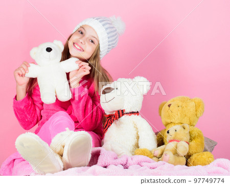 Kid little girl play with soft toy teddy bear on pink background. Toy every child dreaming. Happy childhood concept. Child small girl playful hold teddy bear plush toy. Why kids love stuffed animals Kid little girl play with soft toy teddy bear on pink background. Toy every child dreaming. Happy childhood concept. Child small girl playful hold teddy bear plush toy. Why kids love stuffed animals 97749774