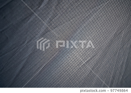 Abstract modern mesh material texture for unusual backdrop. Light weight wrinkled seamless pattern of pale gray plaid fabric for wallpaper or art ideas. Concept of textures and background. 97749864