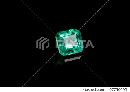 Macro mineral Emerald gemstone faceted on black background Macro mineral Emerald gemstone faceted on black background 97750695