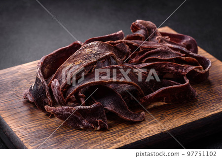 Delicious salted dried beef cut into slices as an appetizer for beer 97751102
