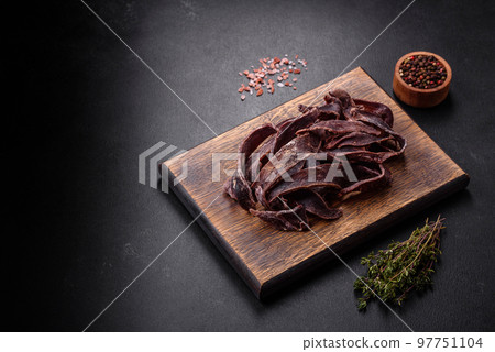 Delicious salted dried beef cut into slices as an appetizer for beer 97751104