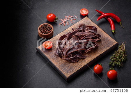 Delicious salted dried beef cut into slices as an appetizer for beer Delicious salted dried beef cut into slices as an appetizer for beer 97751106