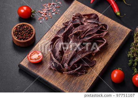 Delicious salted dried beef cut into slices as an appetizer for beer 97751107