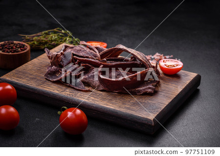 Delicious salted dried beef cut into slices as an appetizer for beer 97751109