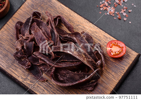 Delicious salted dried beef cut into slices as an appetizer for beer 97751111