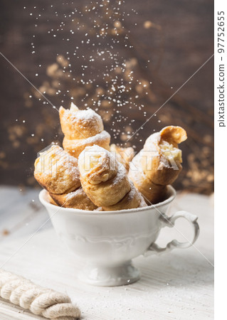 Pastry Tubes with Whipping Cream in the White Cup 97752655
