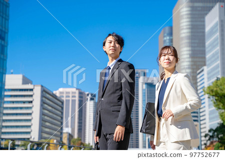 Business scene female male outdoors 97752677