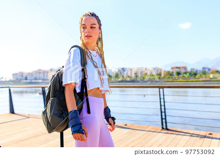 Protective skate safety concept , woman with equipment in beach and mountain background on a summer day 97753092