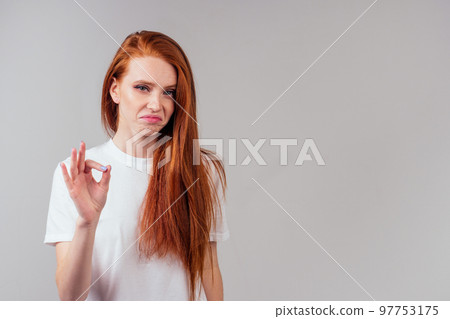 redhair ginger woman in green cotton silk dress in pink studio amazed feeling ok 97753175