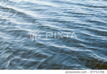 Water surface with ripples 97753786