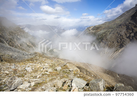Above the clouds in the mountains near the Ried Glacier (Gasenried, Valais, Switzerland) Above the clouds in the mountains near the Ried Glacier (Gasenried, Valais, Switzerland) 97754360