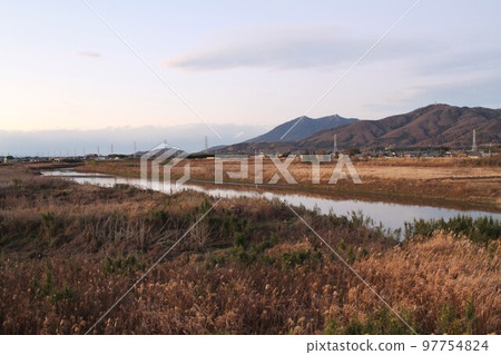 Sakuragawa River, Mt. Hokyo and Mt. Tsukuba under a winter sky, and a sunset with pink clouds 97754824