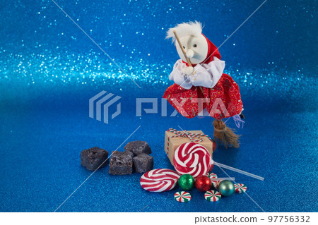 The Befana with sweet coal and candy. Italian Epiphany day tradition. The Befana with sweet coal and candy. Italian Epiphany day tradition. 97756332