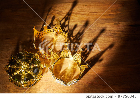 Happy Epiphany day. Three gold crowns on wooden background, symbol of Tres Reyes Magos, Three Wise Men. Happy Epiphany day. Three gold crowns on wooden background, symbol of Tres Reyes Magos, Three Wise Men. 97756343