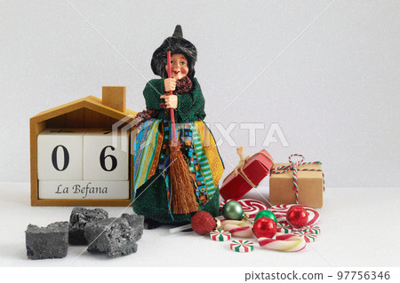 The Befana with sweet coal and candy. Italian Epiphany day tradition. The Befana with sweet coal and candy. Italian Epiphany day tradition. 97756346