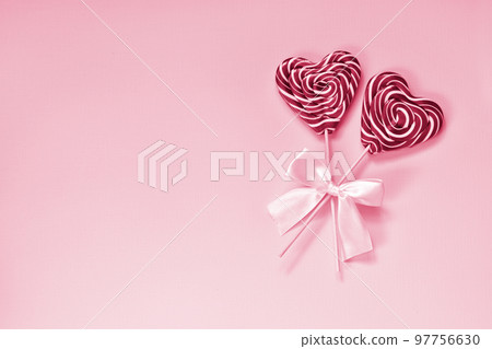 Two bright lollipops with a heart. Postcard minimalism. 97756630