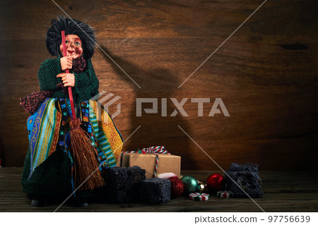 The Befana with sweet coal and candy. Italian Epiphany day tradition. 97756639