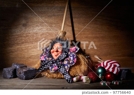 The Befana with sweet coal and candy. Italian Epiphany day tradition. The Befana with sweet coal and candy. Italian Epiphany day tradition. 97756640