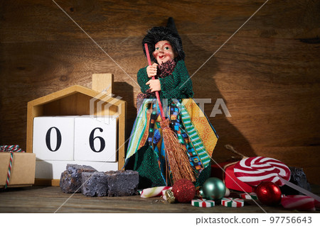 The Befana with sweet coal and candy. Italian Epiphany day tradition. The Befana with sweet coal and candy. Italian Epiphany day tradition. 97756643