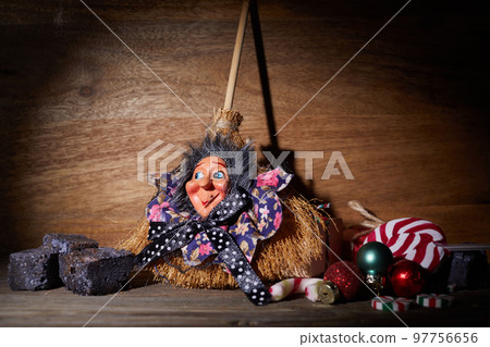 The Befana with sweet coal and candy. Italian Epiphany day tradition. 97756656
