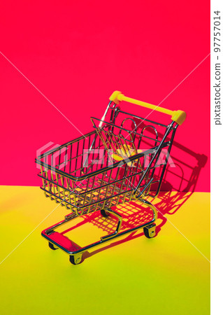Empty shopping trolley cart on colorful orange yellow background. Copy space for your text. Online shopping, buy mall market shop consumer concept. Small toy supermarket grocery push cart. Food Empty shopping trolley cart on colorful orange yellow background. Copy space for your text. Online shopping, buy mall market shop consumer concept. Small toy supermarket grocery push cart. Food 97757014