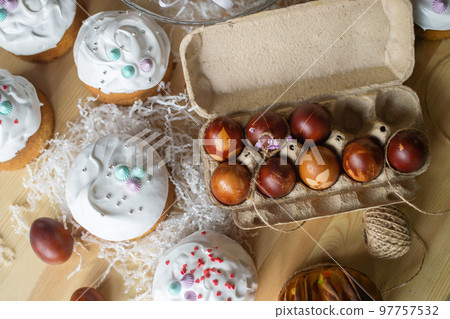 Painted eggs cooked for Easter are in the tray near the pies 97757532