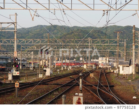 A depot where many orange trains stop at the back of a complicated branching track A depot where many orange trains stop at the back of a complicated branching track 97758128