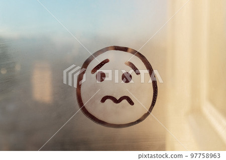 drawn sad face on foggy sunset window raindrops concept photo drawn sad face on foggy sunset window raindrops concept photo 97758963