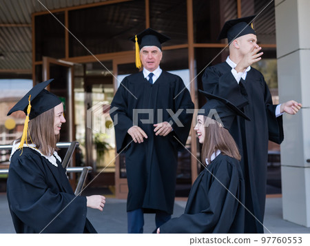 Classmates in graduation gowns. Accessible education for all ages. Classmates in graduation gowns. Accessible education for all ages. 97760553