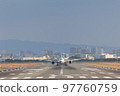 Front view of an airplane about to take off 97760759