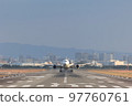 Airplane taking off viewed from the front 97760761