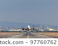 Front view of an airplane taking off 97760762