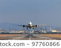 Front view of an airplane taking off 97760866