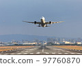 Front view of an airplane taking off 97760870
