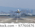 Front view of an airplane taking off from the runway 97760876