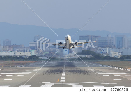 Front view of an airplane taking off from the runway 97760876