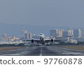 Front view of an airplane taking off from the runway 97760878