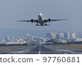 Front view of an airplane taking off from the runway 97760881
