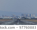 Front view of an airplane taking off from the runway 97760883