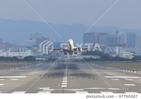 Front view of an airplane taking off from the runway Front view of an airplane taking off from the runway 97760887