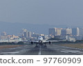 Front view of an airplane taking off from the runway 97760909