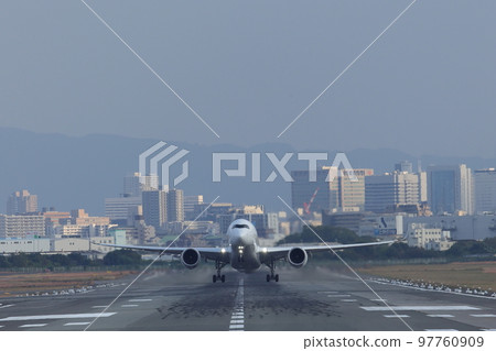 Front view of an airplane taking off from the runway Front view of an airplane taking off from the runway 97760909